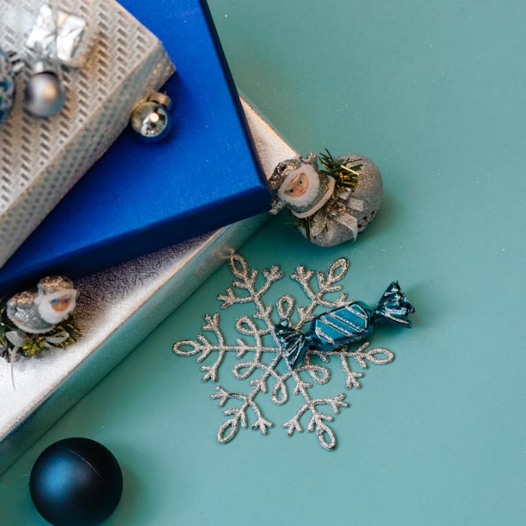 Christmas Gifts and festive decorations on a light blue background.