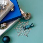 Christmas Gifts and festive decorations on a light blue background.