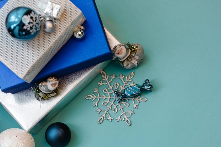 Christmas Gifts and festive decorations on a light blue background.